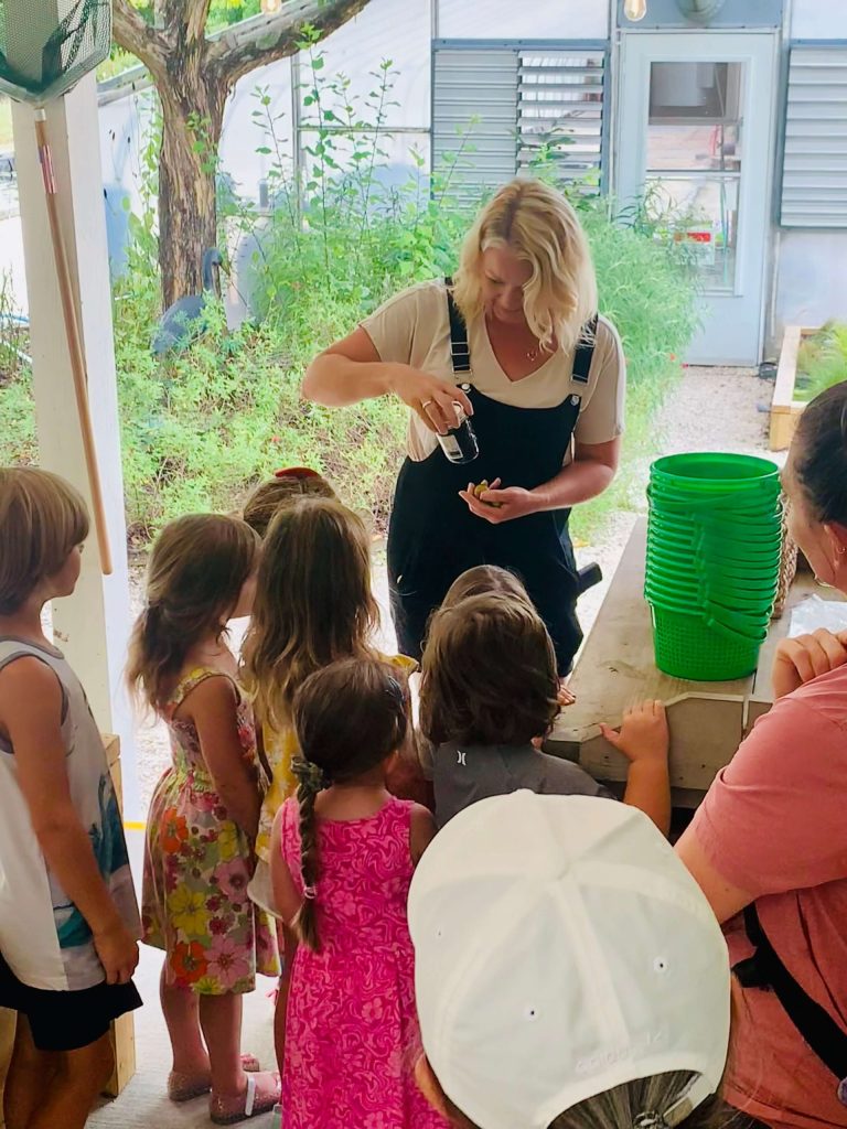 Children watching a hands-on demonstration during a Sandhills Friends outing